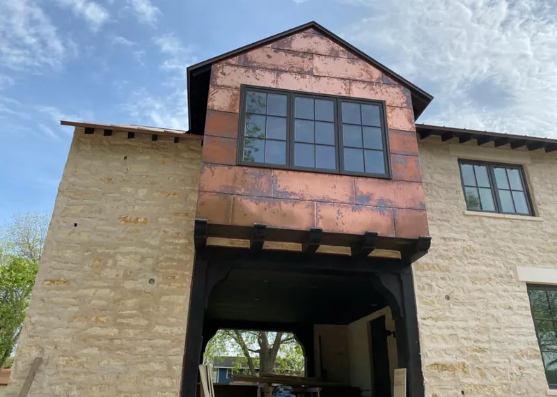 Copper metal panel facade on a stone building for Skylight Installation in Crandall