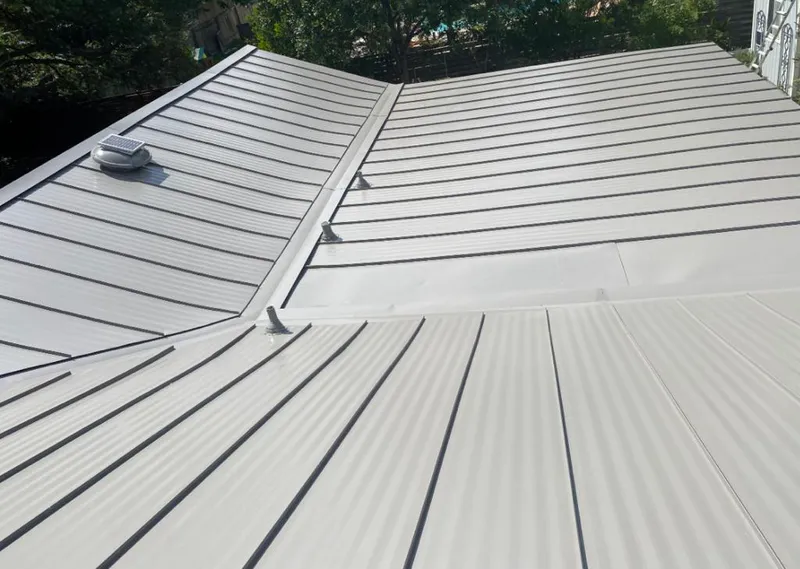 Solar attic fan installed on a metal roof for Roof Ventilation in Crandall